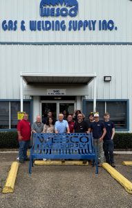 Students and some of WESCO employees are shown with the park bench fabricated by the students of Faulkner Career Tech Center, along with their welding instructor Tim DeVargas